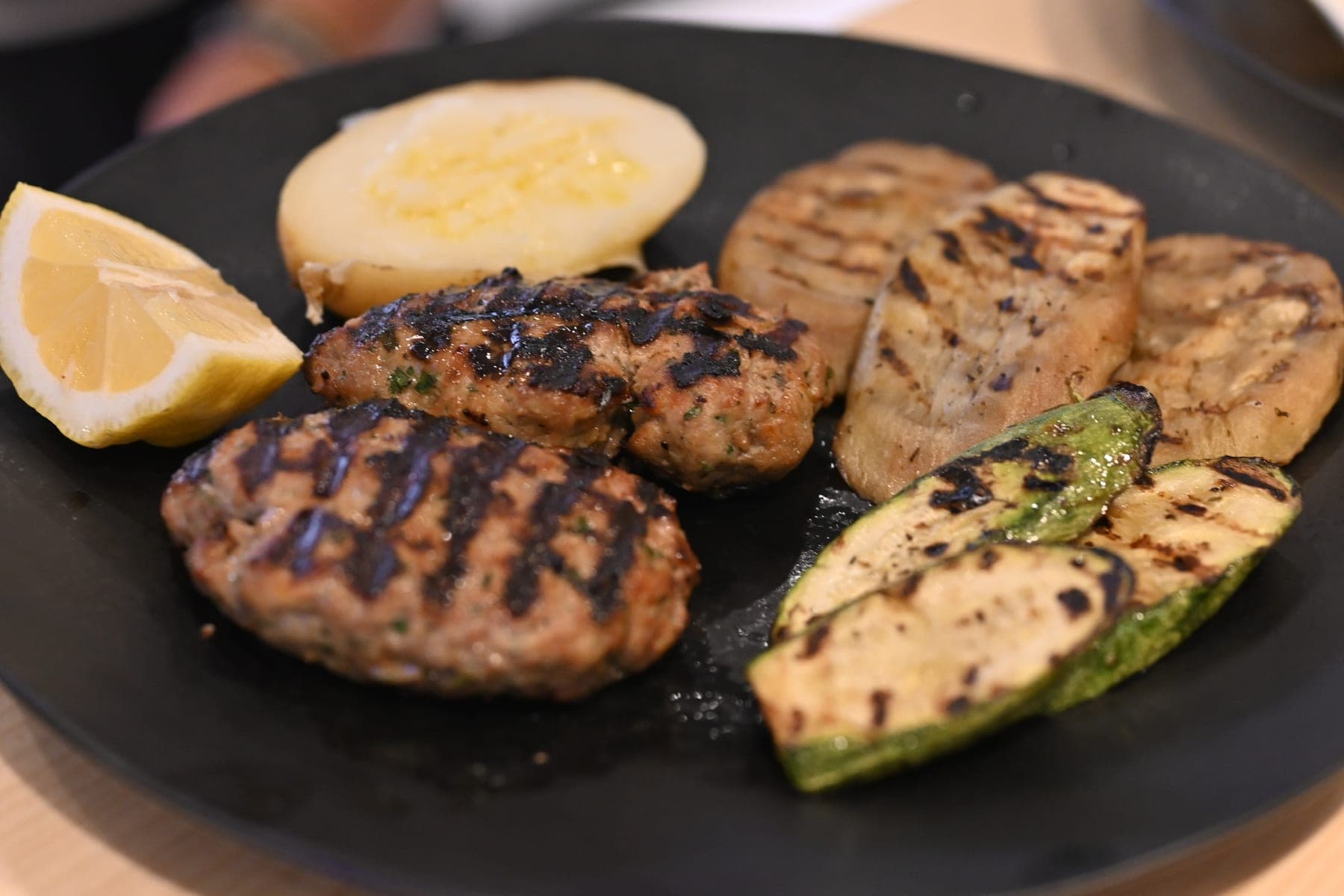 Grilled beef patties with lemon, potato and chargrilled courgette.