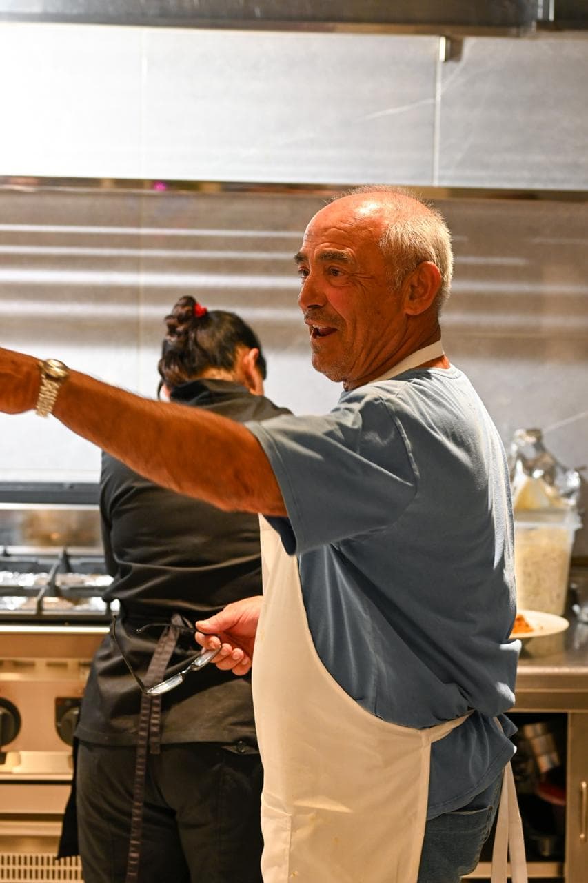 Chef Nikos at work in the open kitchen of Mikri Avra in Mykonos.