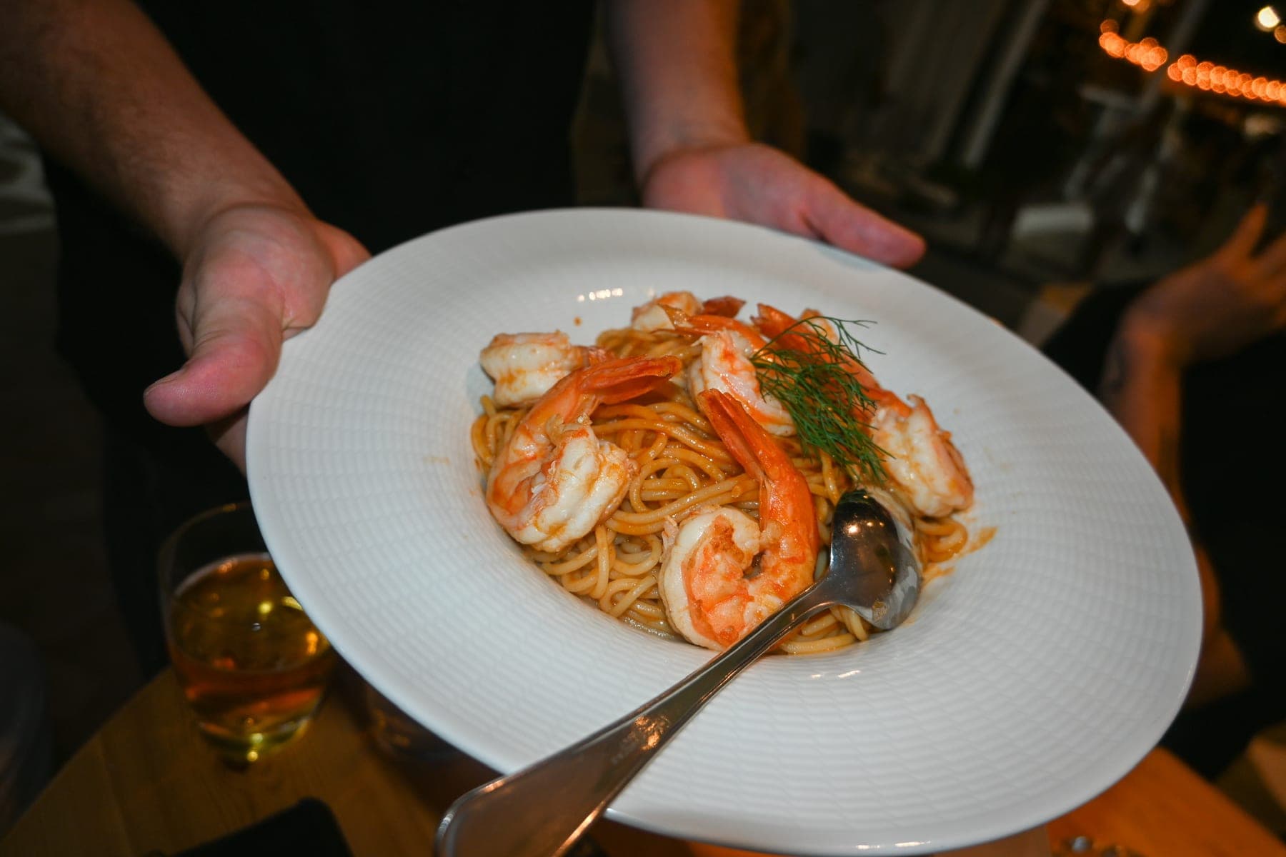 A plate of shrimp spaghetti carried to the table at Mikri Avra.